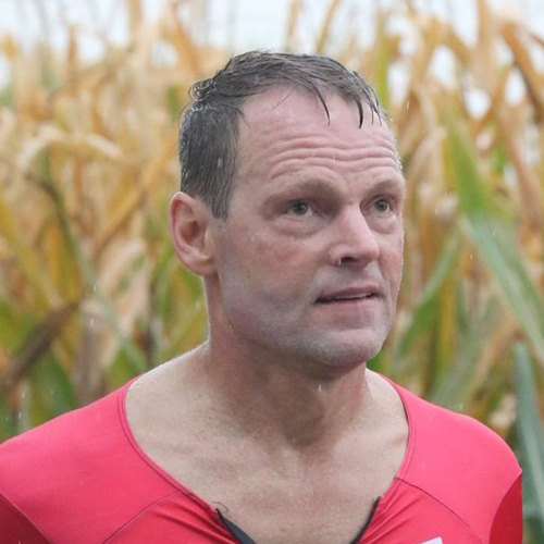 Dave Wilkinson looking wet with corn field in the background