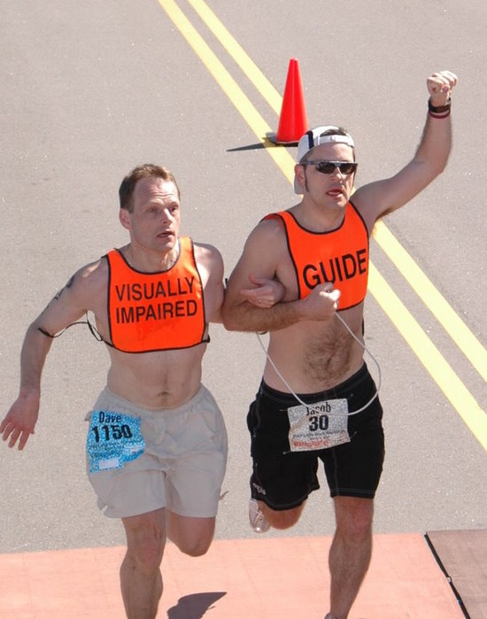 Dave and Jacob Wells running together with Jacob's left hand raised
