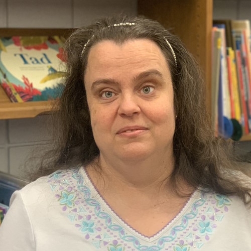 Profile photo of Dawn Wilkinson with library book shelves background